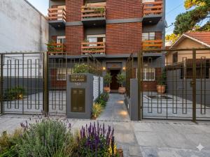 a building with a gate and flowers in front of it at San bernardo relax in San Bernardo