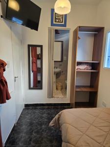 a bedroom with a bed and a sink and a mirror at Espacio Verde in Salta