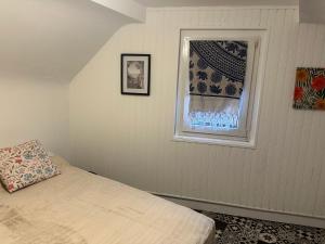 a bedroom with a bed and a window at Alsacian home in Eckbolsheim