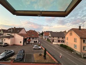 a view of a town with cars parked on a street at Alsacian home in Eckbolsheim