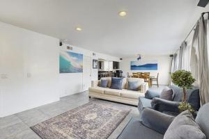 a living room with two couches and a table at Upper Level Beach Retreat in Newport Beach