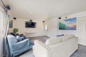 a living room with a couch and two chairs at Upper Level Beach Retreat in Newport Beach