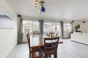 a dining room with a table and chairs and a couch at Upper Level Beach Retreat in Newport Beach +21 photos