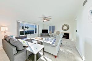 a living room with a couch and a fireplace at Pier View Paradise in San Clemente
