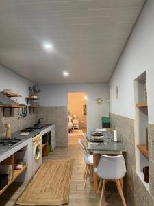 a kitchen and dining room with a table and chairs at Casa dos Andrés in Calheta +21 photos