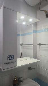 a bathroom with a sink and a mirror at Βeachfront Luxury Apartments SARANDE in Sarandë +55 photos