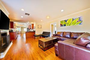 a living room with a couch and a tv at Dream Getaway in Anaheim