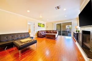 a living room with a leather couch and a table at Dream Getaway in Anaheim