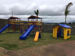 a playground with a slide and a play structure at Catarina Condomínio Clube in Mairinque