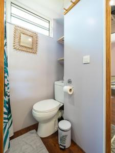 a bathroom with a toilet and a window at Fare AGT Moorea in Afareaitu +9 photos