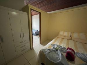 a bedroom with a bed with a bow on it at Flat Amarração Shopping in Luis Correia