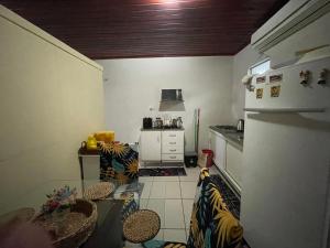 a kitchen with a white refrigerator and a counter at Flat Amarração Shopping in Luis Correia +8 photos