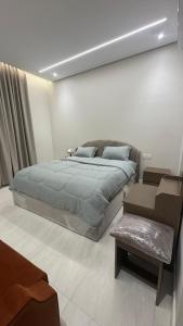 a bedroom with a large bed and a couch at سويت بغرفة نوم شوحط in Abha +4 photos