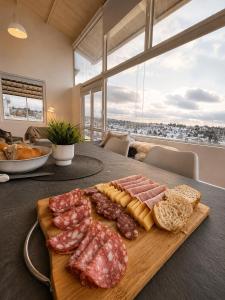 a cutting board with meats and cheese on a table at Alta Vista in Villa Yacanto