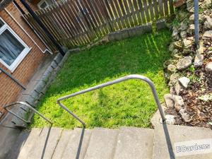 a hand rail on the stairs in a yard at E Gardens Apartment in Nottingham
