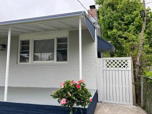 a house with a white gate and a potted plant at Coastal Home at Edgewater in Pleasantville