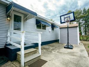 a basketball hoop on the side of a house at Coastal Home at Edgewater in Pleasantville