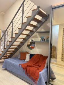 a bedroom with a bed under a staircase at Casa Loft 9C in São Luís +83 photos