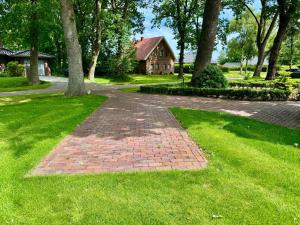 a brick path in front of a house at Ferienwohnung Marita 35681 in Uplengen +16 photos