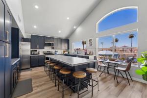 a kitchen with a large island with bar stools at Resort-Style 5BR Heated Pool Putting Green in Glendale