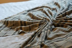 a close up of a blanket on a bed at BrightCentral Apartment With Parking in Glasgow