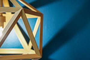 a wooden lantern hanging from a blue wall at BrightCentral Apartment With Parking in Glasgow