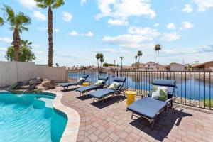 a patio with chairs next to a swimming pool at Resort-Style 5BR Heated Pool Putting Green in Glendale