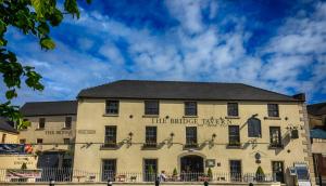 a large white building with a sign on it at The Bridge Tavern in Wicklow