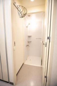 a bathroom with a walk in shower and a toilet at Sakura Hostel Asakusa in Tokyo +23 photos