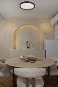 a kitchen with a wooden table and a sink at פנינת חמד Pninat Chemed in Safed