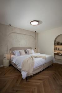 a bedroom with a large bed with white sheets and pillows at פנינת חמד Pninat Chemed in Safed