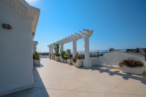 a row of potted plants on a patio with the ocean at Les Pins in Cannes