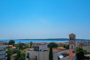 a view of a city with a clock tower at Les Pins in Cannes