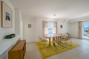 a living room with a dining room table and chairs at Les Pins in Cannes +13 photos