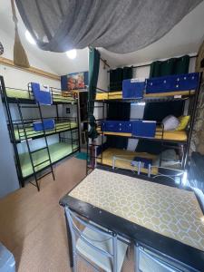 a room with bunk beds and a table in it at Maison Donasete voyageurs in Vieille-Brioude