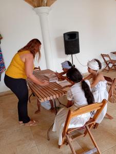 a group of women sitting at a table at EBORA cultura afro in Ilhéus