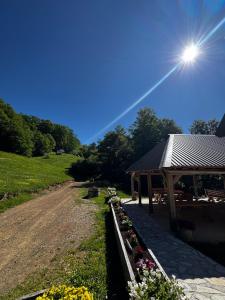 a dirt road next to a building with a roof at Melaya 1600 in Kolašin +6 photos