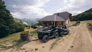 an atv parked on a dirt road in front of a house at Melaya 1600 in Kolašin