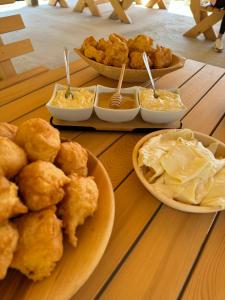 a table with three plates of food and dip at Melaya 1600 in Kolašin