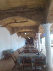 a group of tables and chairs in a room at EBORA cultura afro in Ilhéus