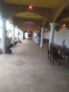 an empty hallway with tables and chairs in a building at EBORA cultura afro in Ilhéus +14 photos