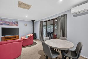 a living room with a couch and a table at The Brynes Hideaway - On Brynes Road in Goolwa