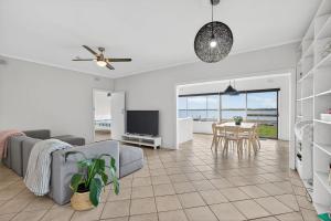 a living room with a couch and a table at Barnacles Shack - Mills Road in Hindmarsh Island