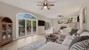 a living room with a couch and a table at Poolside Paradise by AvantStay in Sherrills Ford