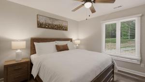 a bedroom with a bed and a ceiling fan at Poolside Paradise by AvantStay in Sherrills Ford +58 photos