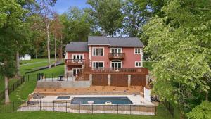 a house with a swimming pool in front of it at Poolside Paradise by AvantStay in Sherrills Ford