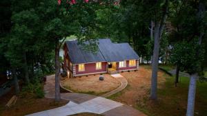 a small house in the middle of a forest at Poolside Paradise by AvantStay in Sherrills Ford