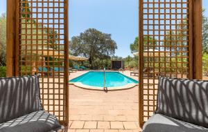a swimming pool with a gate and two chairs at Estrella - Son Jorbo in Porreres