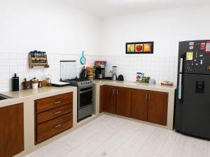 a kitchen with a stove and a refrigerator at Casa Hotel La Unión in Santa Cruz de Mompox +5 photos