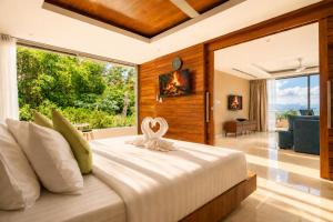 a bedroom with a large bed with a large window at Villa Skyfall Thailand Phuket in Panwa Beach +137 photos